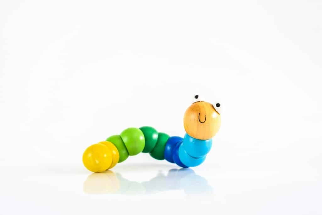 Toy caterpillar with smile, to illustrate concepts of infant intestinal health.